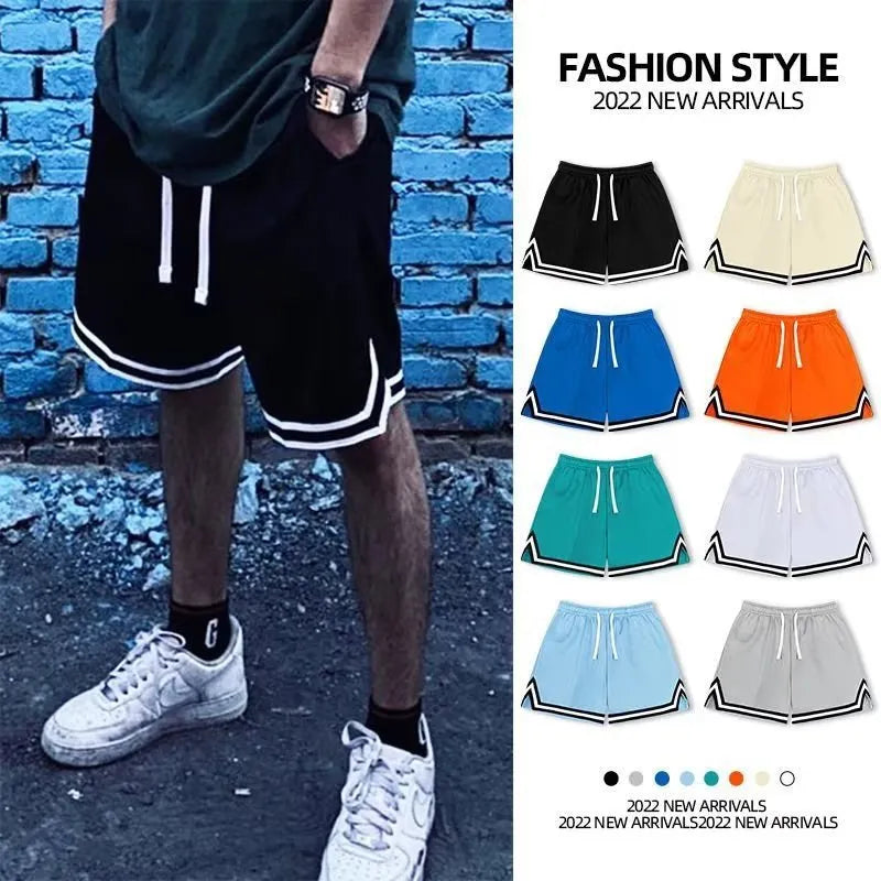 Man wearing loose-fit apricot coloured polyester sports shorts with an elastic waistband.