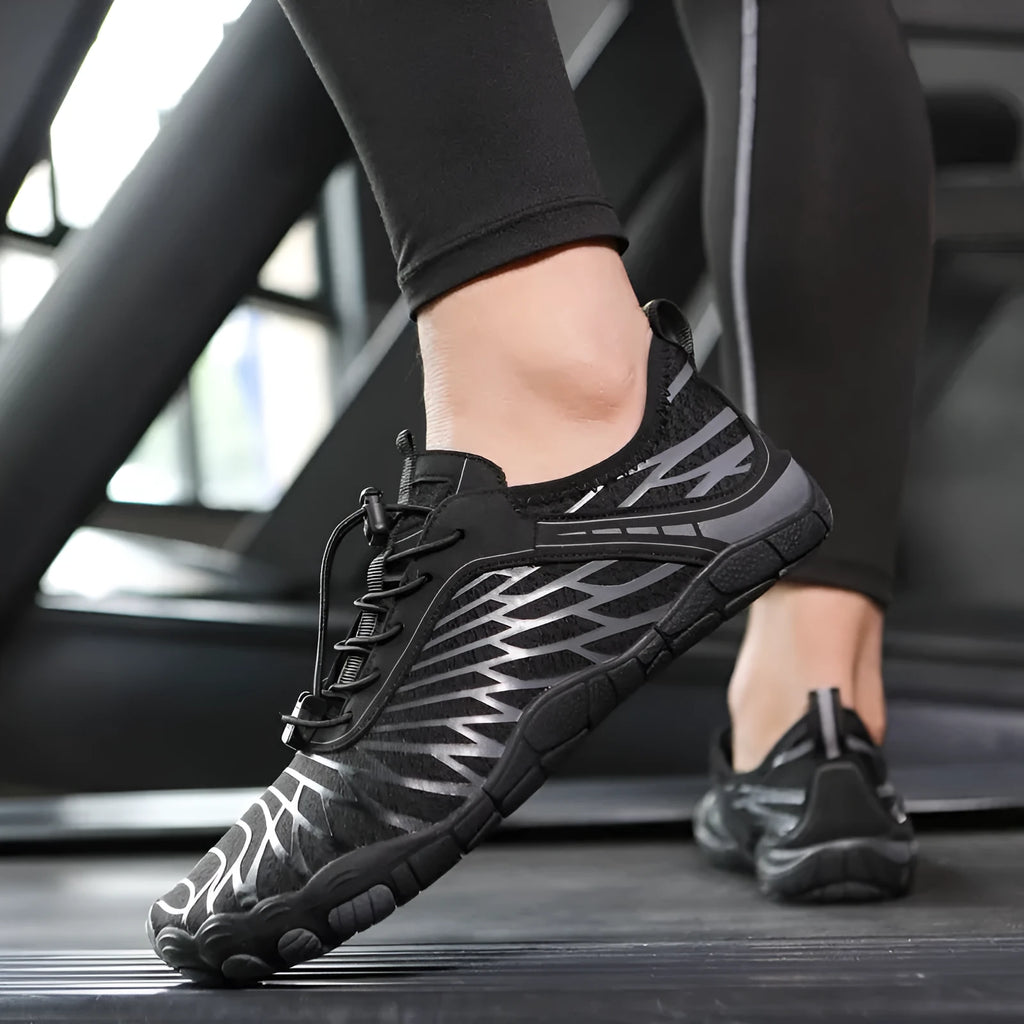 Pair of white lace-up outdoor sports shoes with a non-slip rubber sole on a plain background.