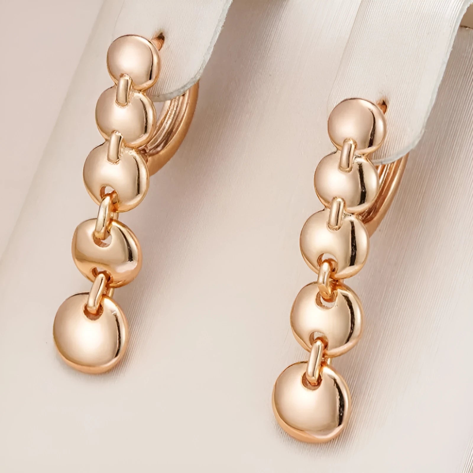A pair of gold-coloured retro long round circle earrings with a woven copper design.