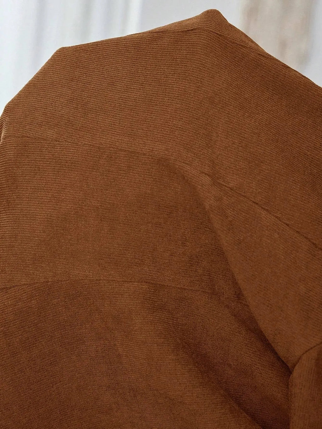 Brown single-breasted lapel blazer for men on a hanger.