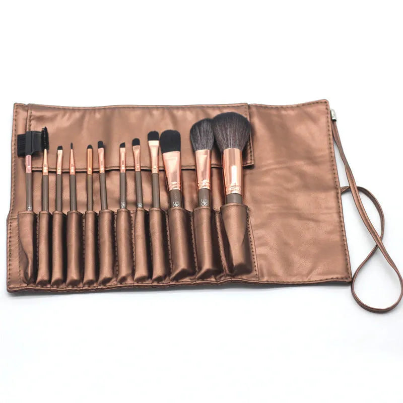 Multi-function makeup brush set with synthetic fibre bristles, long plastic handles, and brown PU storage bag on a flat surface