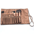 Multi-function makeup brush set with synthetic fibre bristles, long plastic handles, and brown PU storage bag on a flat surface