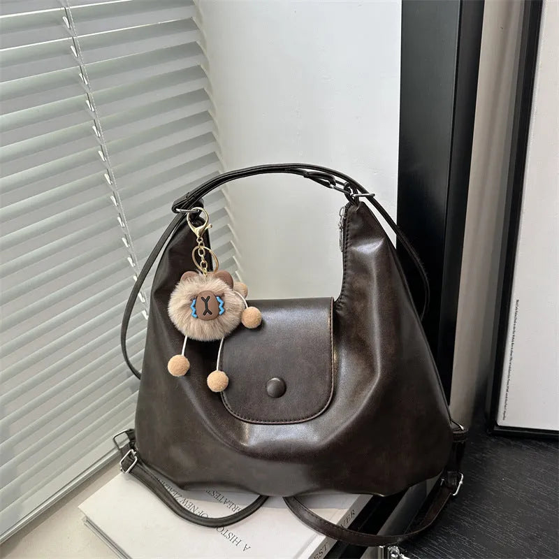 Textured PU leather women's shoulder bag with horizontal square shape and single strap in commuter backpack design