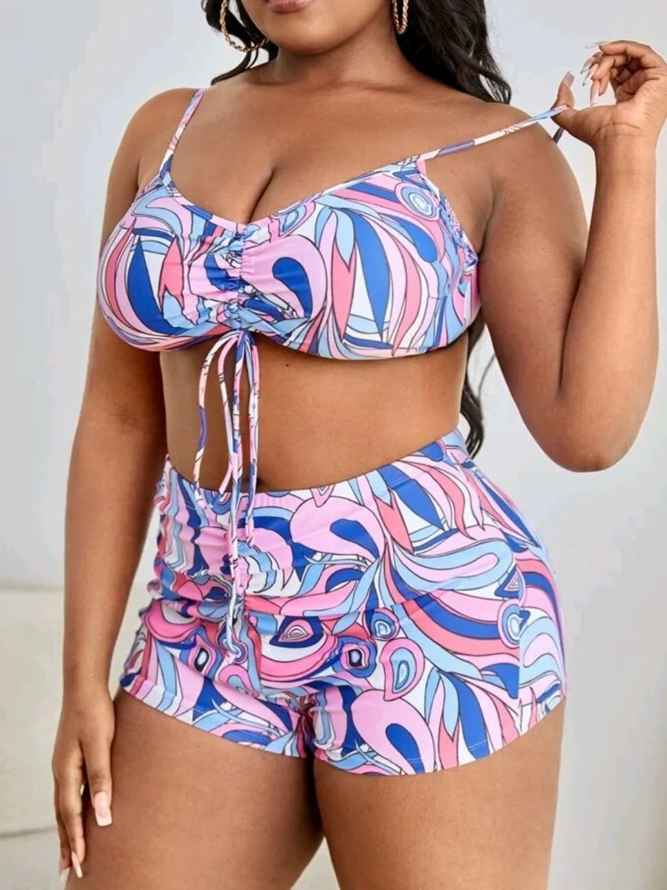 Women's floral print polyester bikini three-piece set with bra, shorts, and cardigan.
