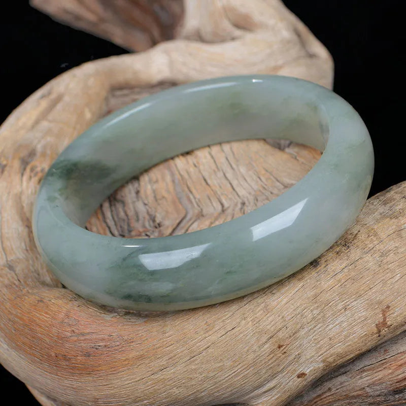 Natural Jinsi Jade Chinese style bracelet in a bangle shape on a plain background.
