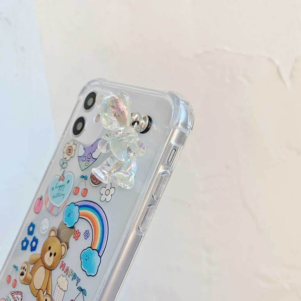 White TPU iPhone case with an attached silver bear pendant on a chain, showing cartoon-style design.