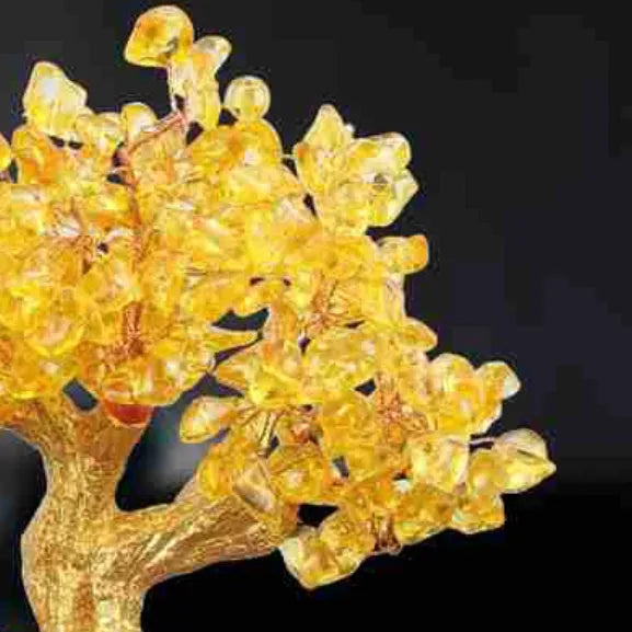 Citrine-coloured resin Feng Shui ornament of a small water turtle money tree on a white background.