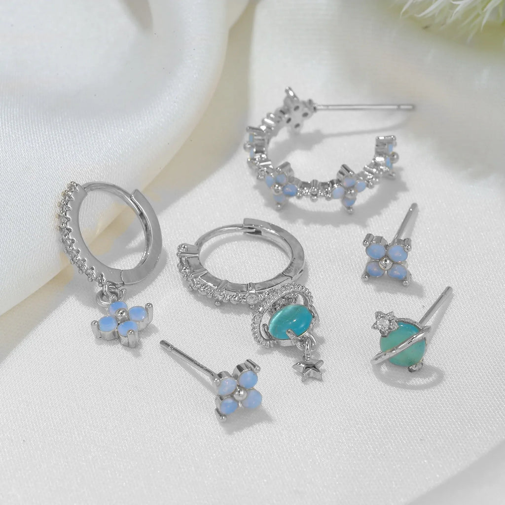Gold and silver floral ear studs with zircon mosaic details in Japanese Korean style.