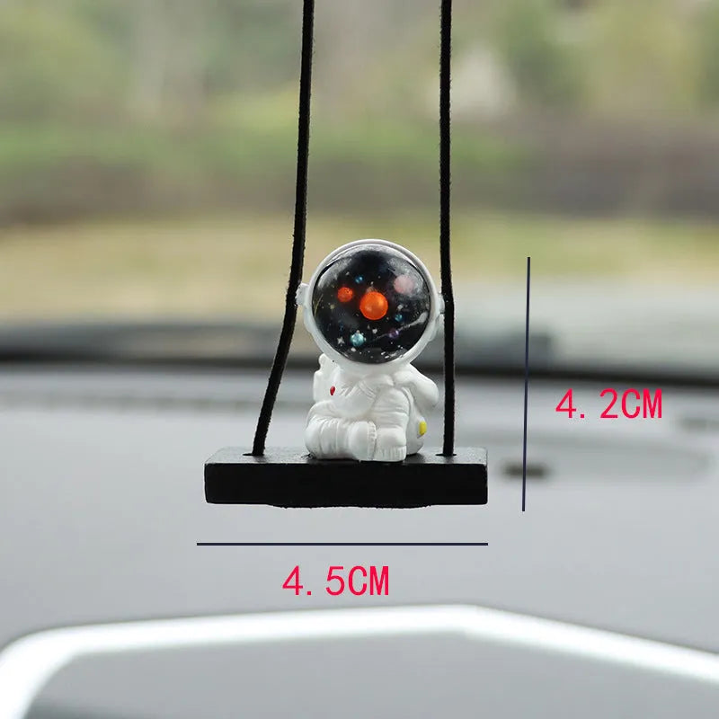 Cartoon style resin astronaut car pendant in five different colour and design variants.