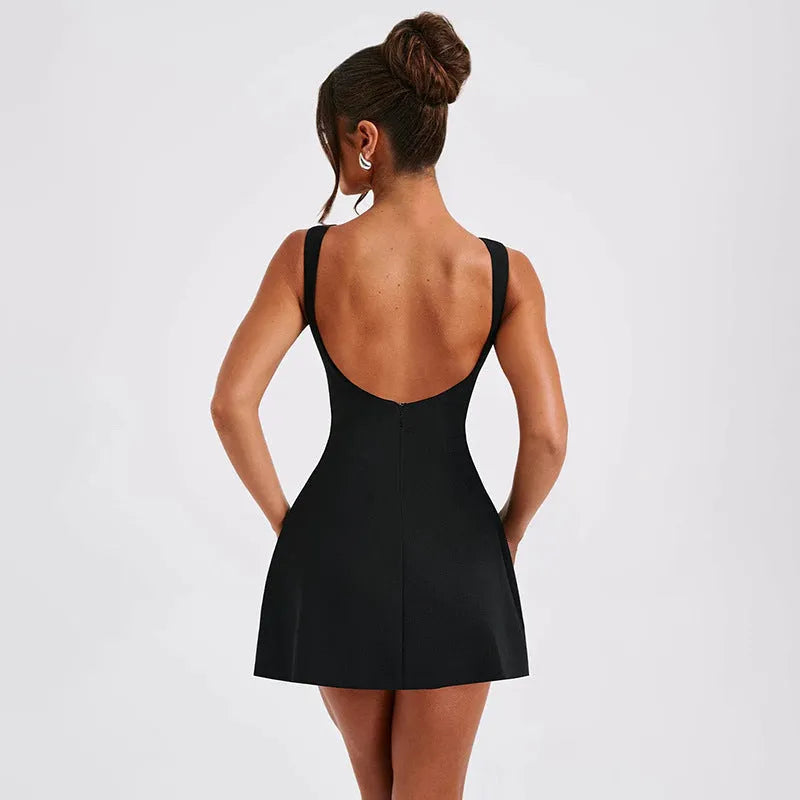 A woman wearing a slim-fitting black backless sleeveless dress with a high waist and short skirt.
