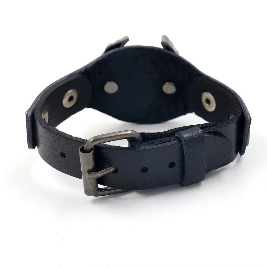 Black leather bracelet with a geometric alloy eagle decoration, showing the band's width variation.