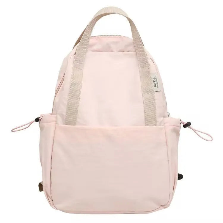 Solid colour nylon backpack with curved shoulder straps shown in five colour options