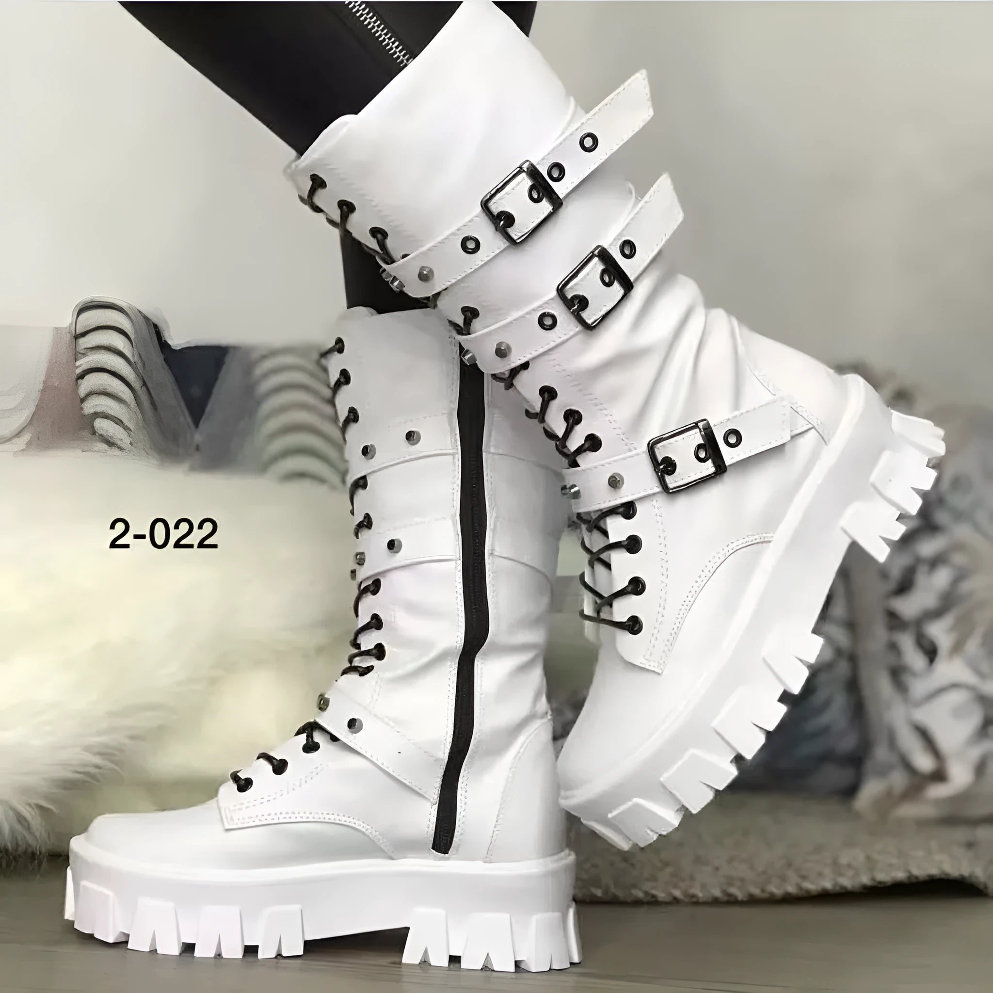 Black women's mid-calf knight boots with metal buckle detail and side zip on a white background