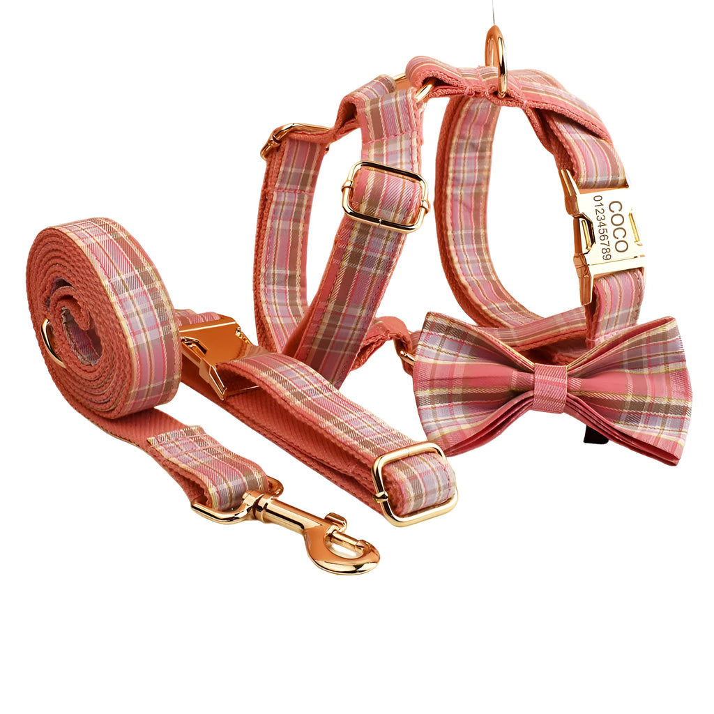 Plaid pattern dog collar and leash set with red bow tie accessory on cloth fabric