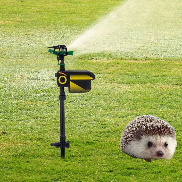 Black automatic PIR animal repellent garden sprinkler made of ABS plastic with rotating nozzle on grass