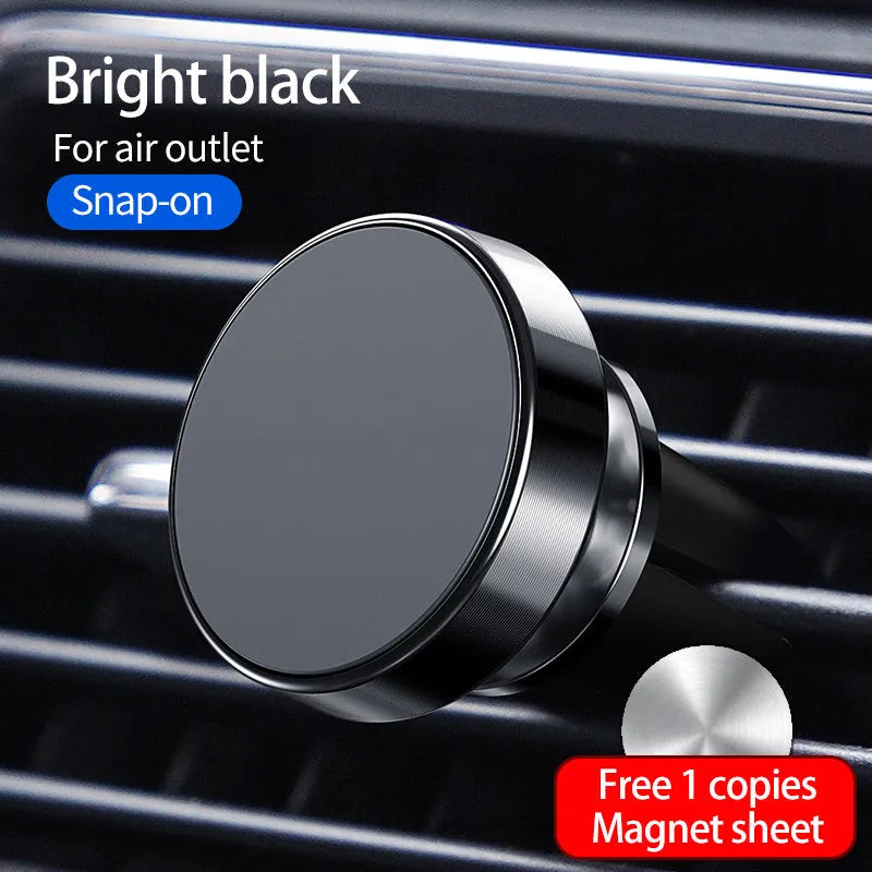 Black magnetic car phone holder mounted on a car dashboard, holding a smartphone