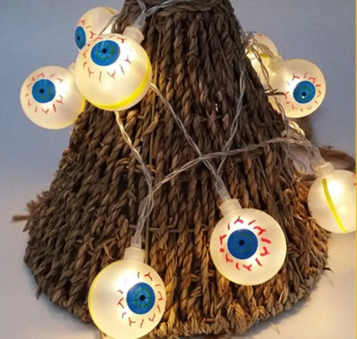 Halloween LED string lights with pumpkin, bat, and ghost decorations hanging on a wall