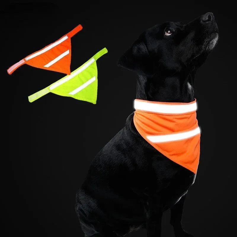 Yellow and orange reflective dog bandana with striped design and adhesive strap, shown on a dog's neck.