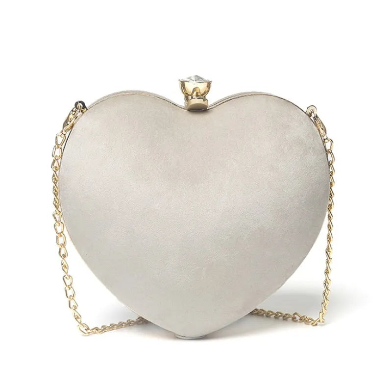 Heart-shaped plush cotton chain bag with card pocket in pink colour on plain background