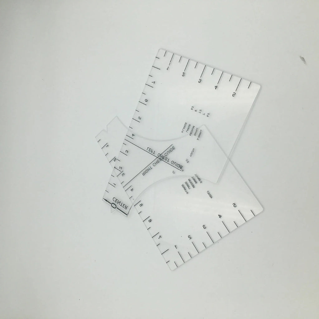 Transparent acrylic sewing ruler for T-shirt alignment and patch placement on fabric.