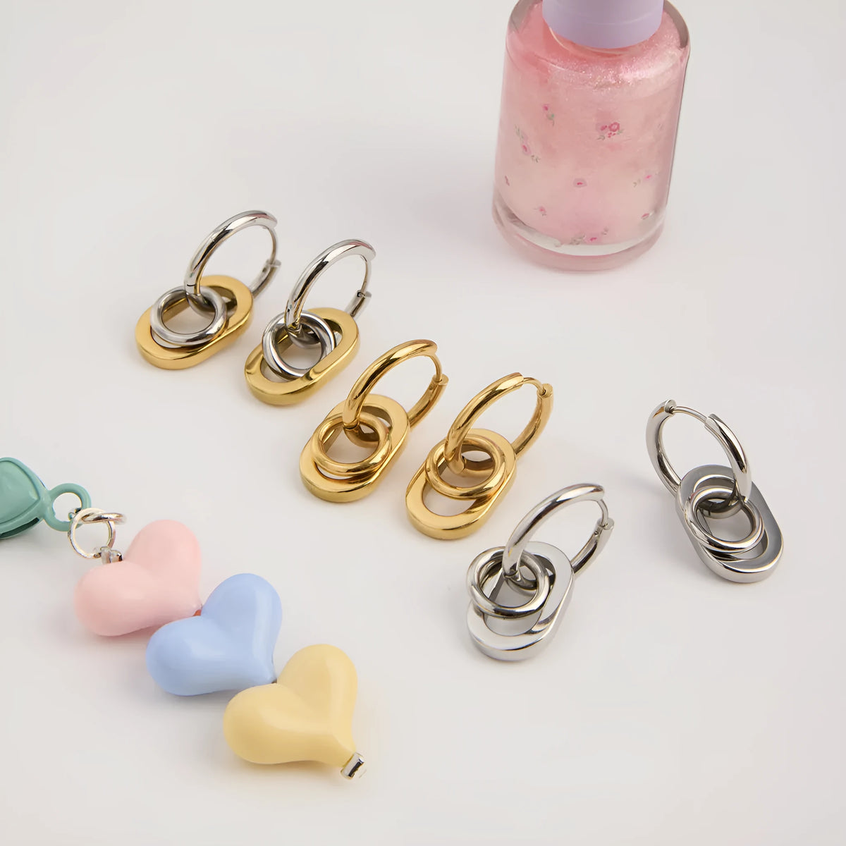Pair of stainless steel geometric ear studs for women with electroplated finish, available in four colours.
