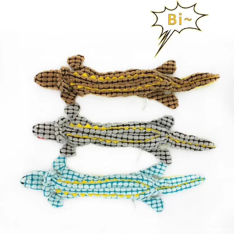 Blue corduroy crocodile-shaped squeaky dog toy shown next to size measurement