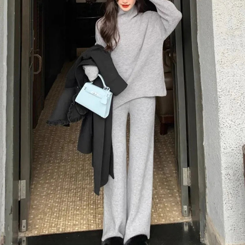 Women's milky white acrylic knit sweater and wide-leg trouser two-piece set on a hanger.