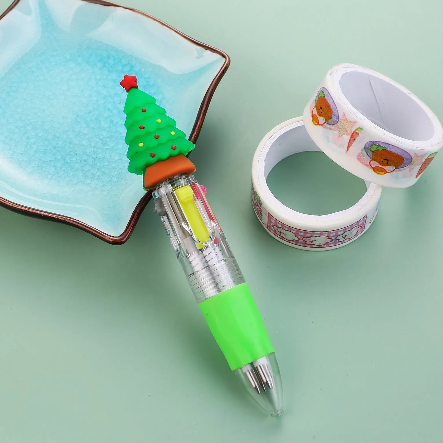 Compact 11cm Christmas ballpoint pen with four colours and festive designs like snowmen and reindeer.