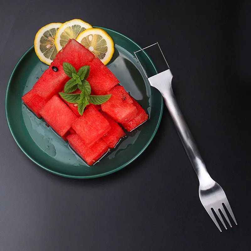 Stainless steel watermelon slicer and fork tool on a kitchen counter