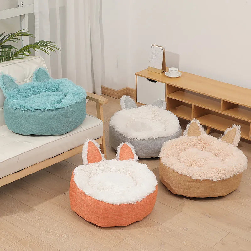 Round plush faux fur cat bed with raised sides in blue colour showing soft texture