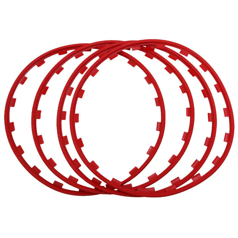 Set of four white nylon wheel hub protection rings for alloy wheels on a grey background.