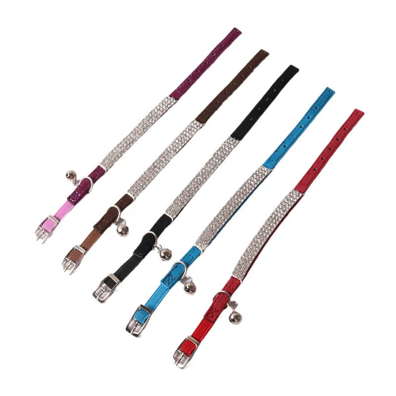 Elastic buckle cat collar in flocking fabric with gang drill detail, shown in multiple colours.