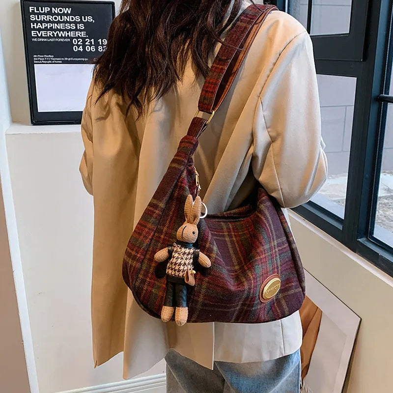 Women's woolen shoulder bag in horizontal square shape with cross-body strap and decorative sewing lines