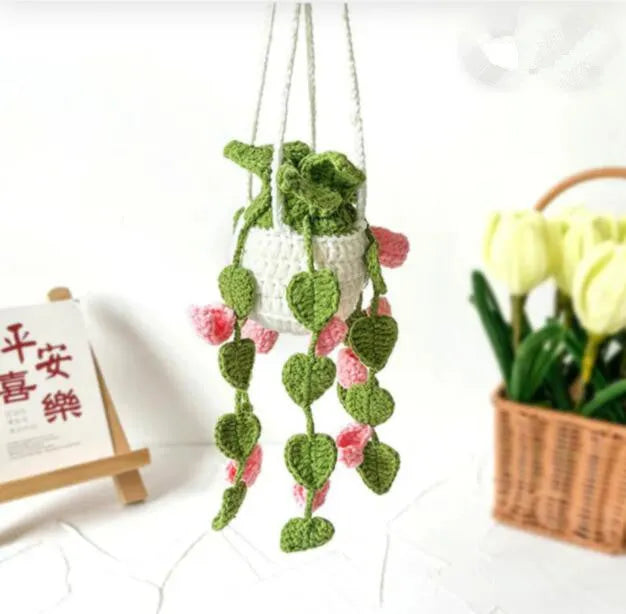 Green and white knitted wool car plant decoration with basin base and hanging rope