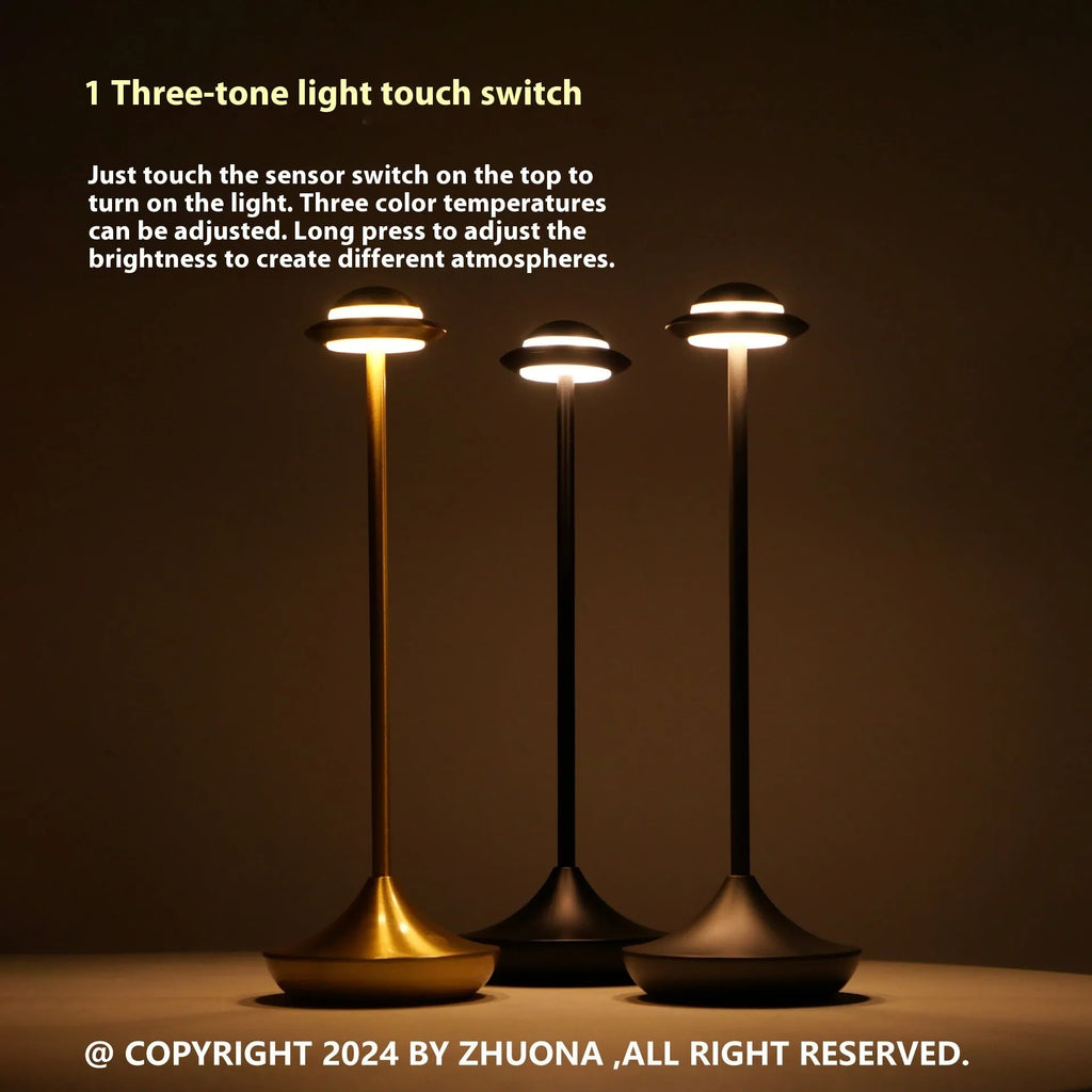 Modern UFO-shaped metal table lamp in grey on a wooden desk, showing touch controls and sleek design.