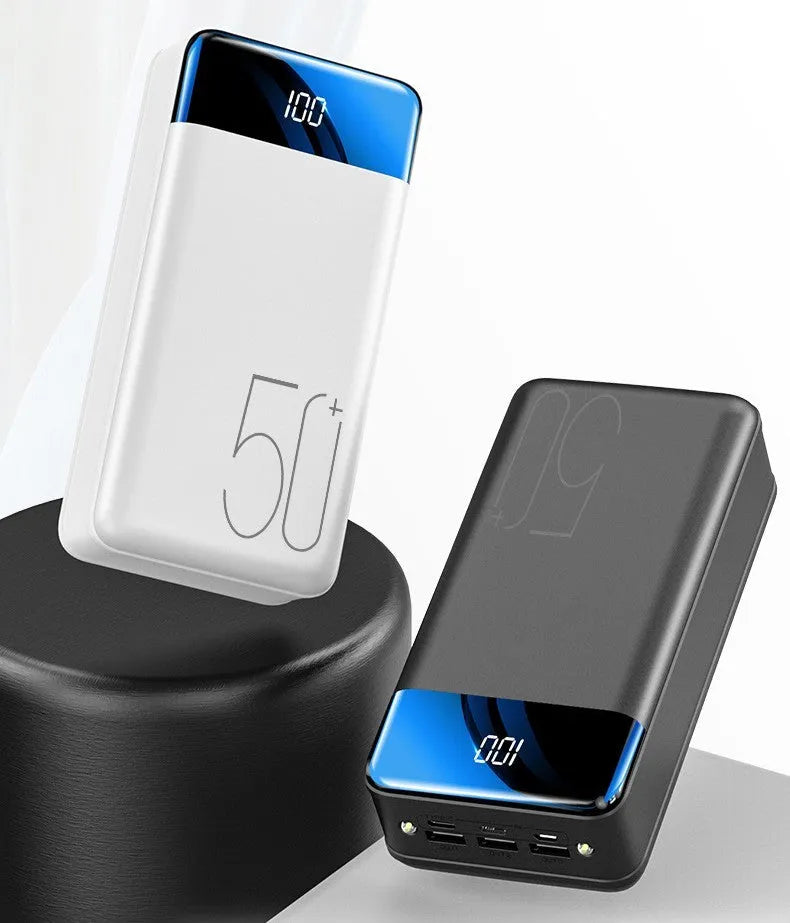 Black and white 50000mAh power bank showing three USB output ports and its large form factor.