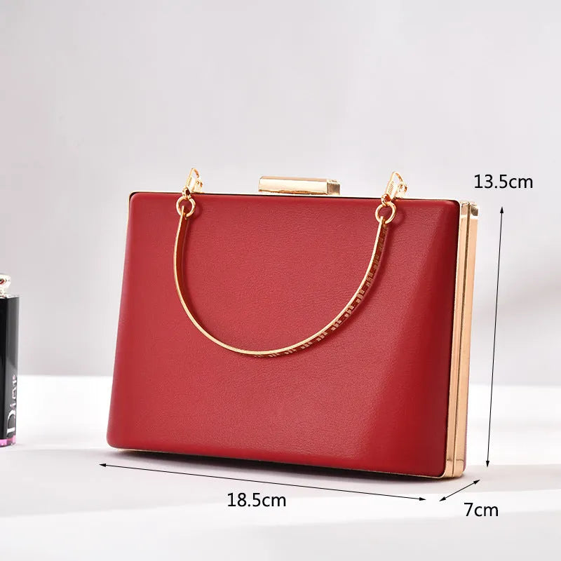 Solid colour PU leather crossbody bag in pillow shape with double-ring detail, 18.5x13.5x7cm, in black.