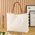 Beige white canvas tote bag with long handles and a front view showing its structured shape