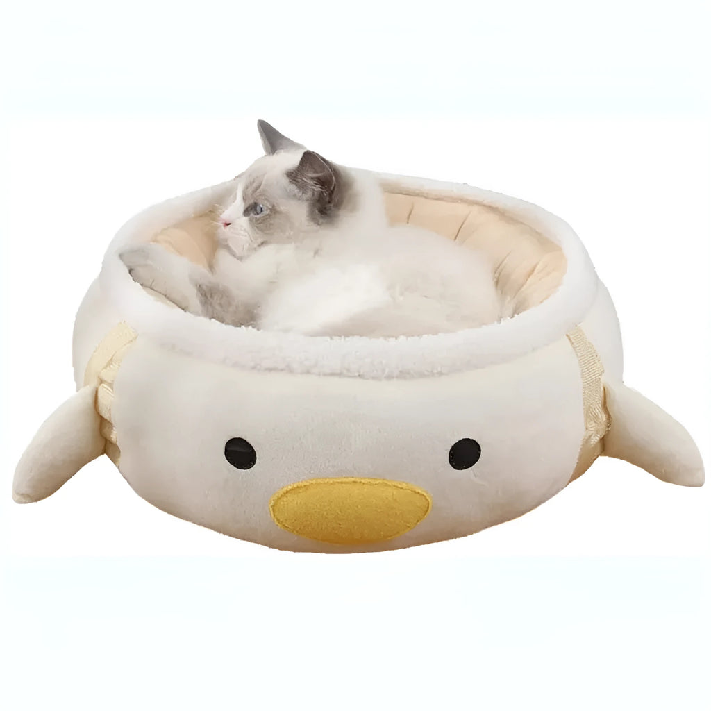 Green dinosaur and chick shaped cat bed shown both flat and hanging as a hammock.