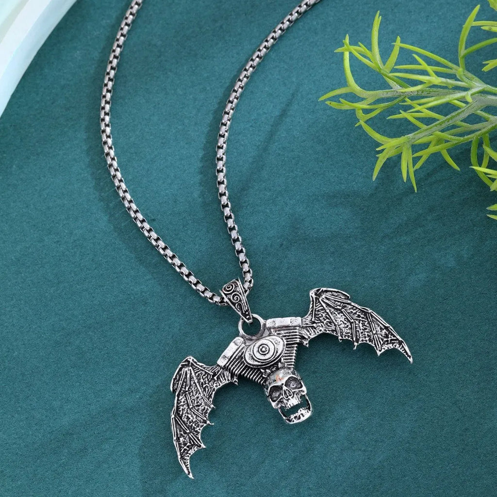 Gothic dark alloy skull pendant necklace with skeleton wing detail on matte black background