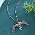 Gothic dark alloy skull pendant necklace with skeleton wing detail on matte black background