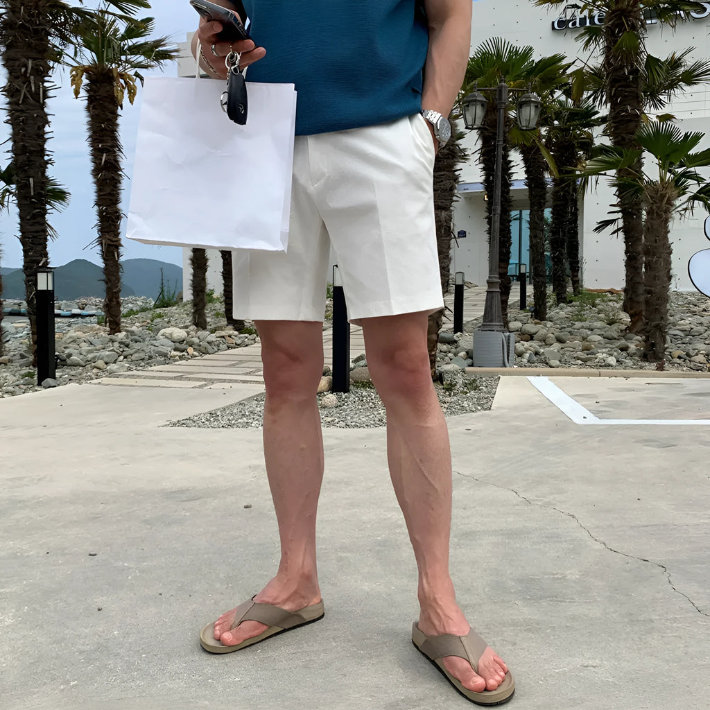 Men's straight-leg casual shorts in solid black, white, or khaki colour made from polyester fabric.