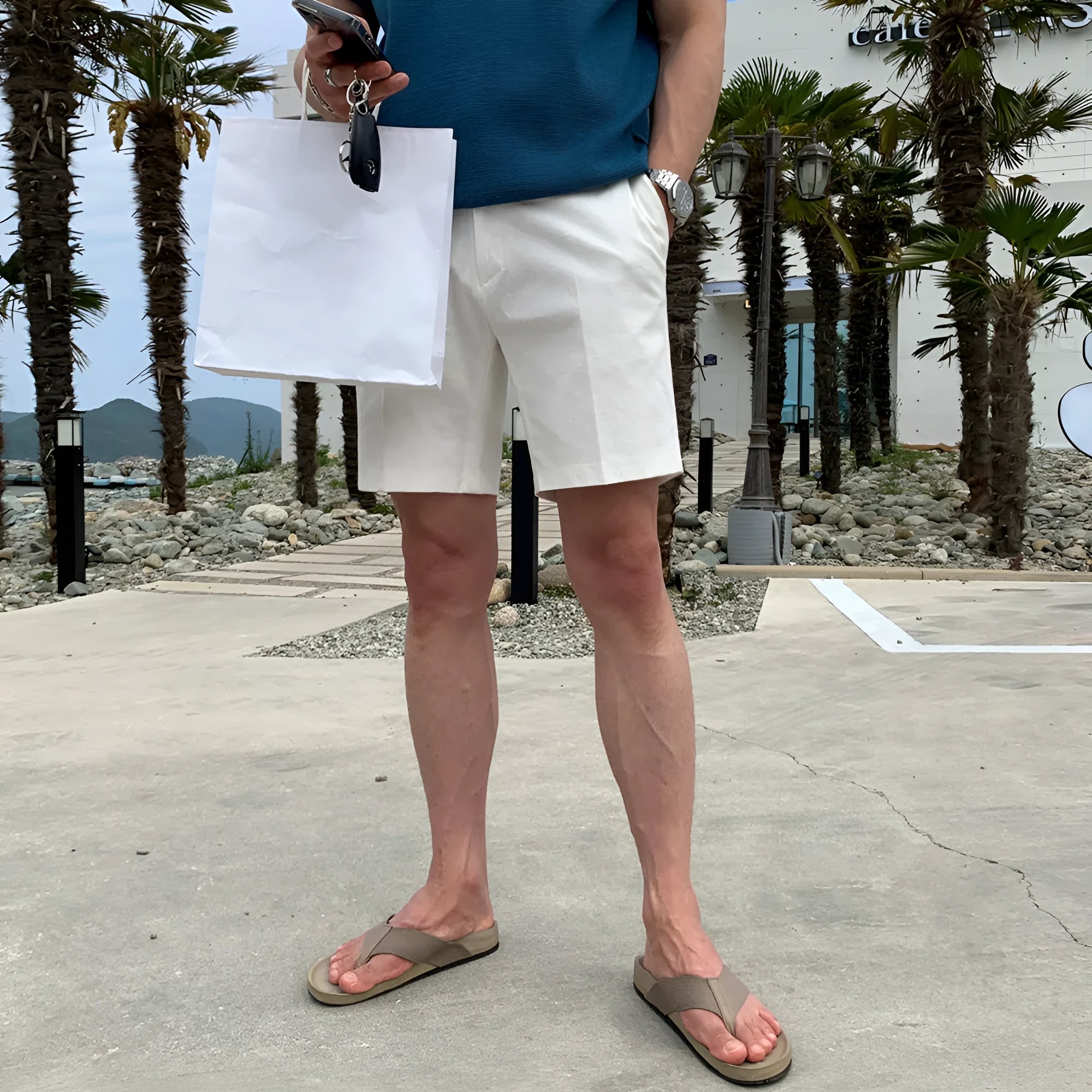 Men's straight-leg casual shorts in solid black, white, or khaki colour made from polyester fabric.