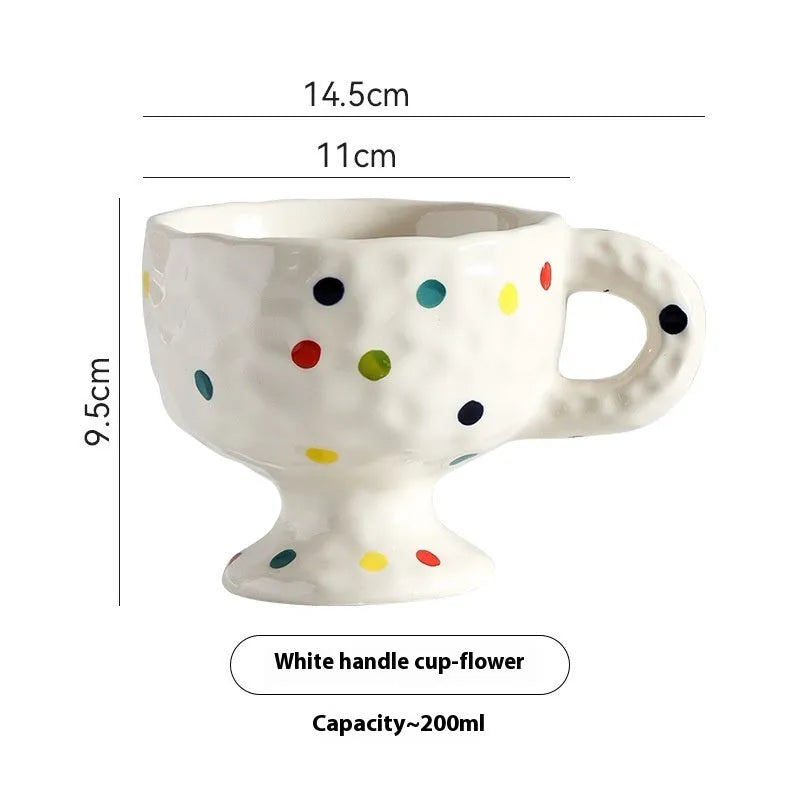 Irregularly shaped hand-pinched ceramic mug in a solid colour, shown on a plain background.