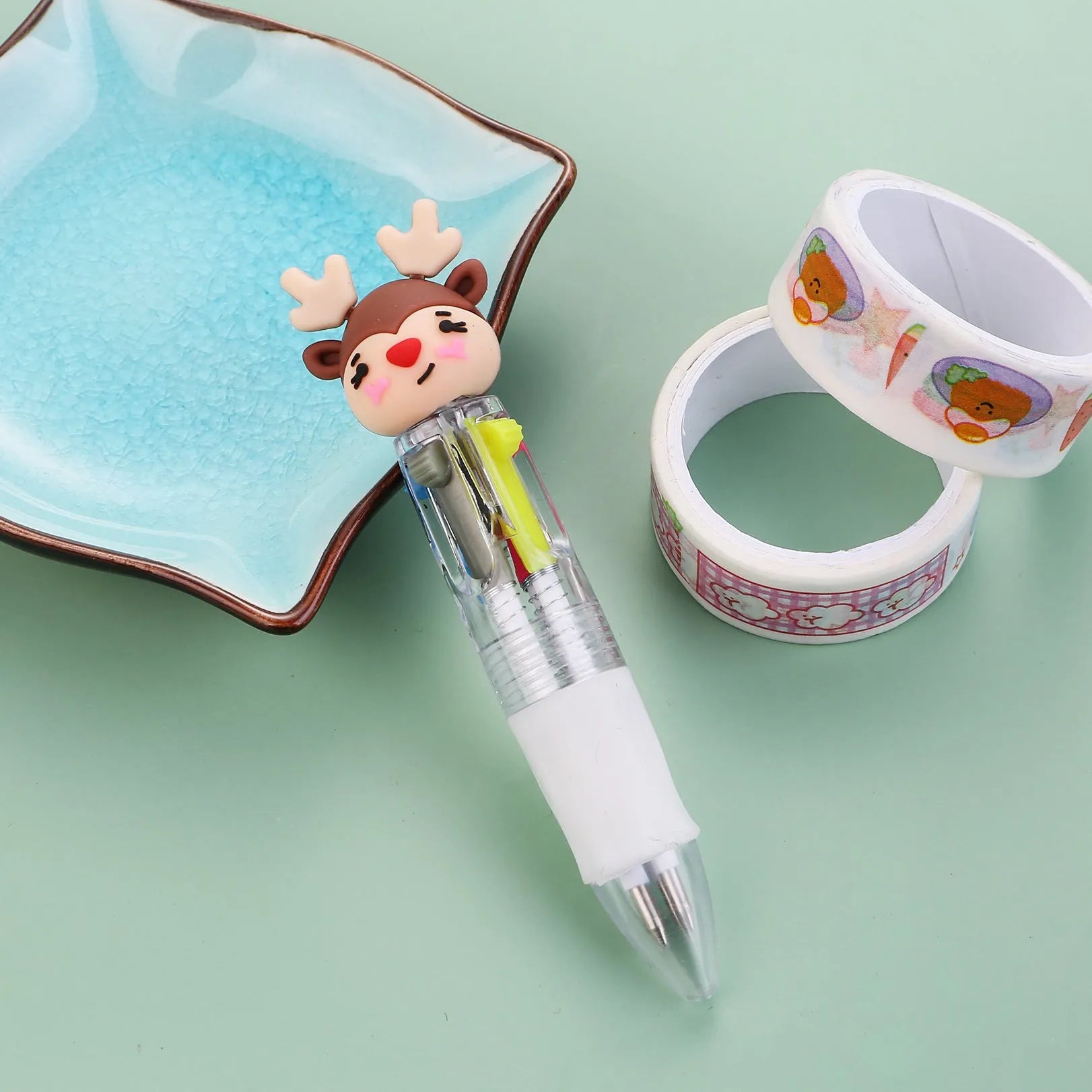 Compact 11cm Christmas ballpoint pen with four colours and festive designs like snowmen and reindeer.