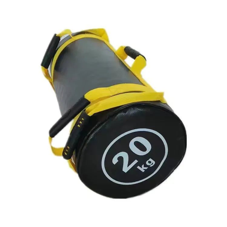 Flat white PVC fitness sandbag on gym floor, showing size and sturdy handles for weight training.