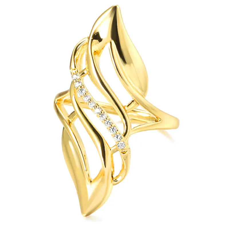 Gold women's ring with exaggerated curved design on a copper band, shown in casual style.