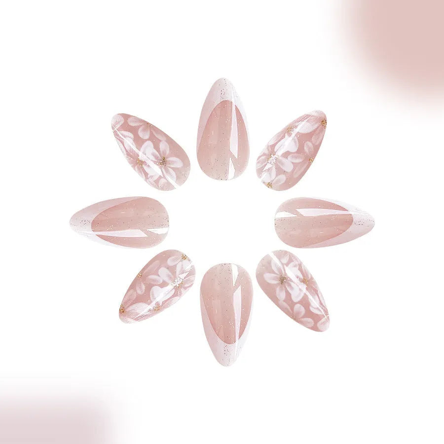 Short glossy almond French style false nails with glittering flower pattern in colour C625