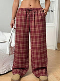 Blue women's loose fit casual trousers with a drawstring waist and front pockets on a hanger.