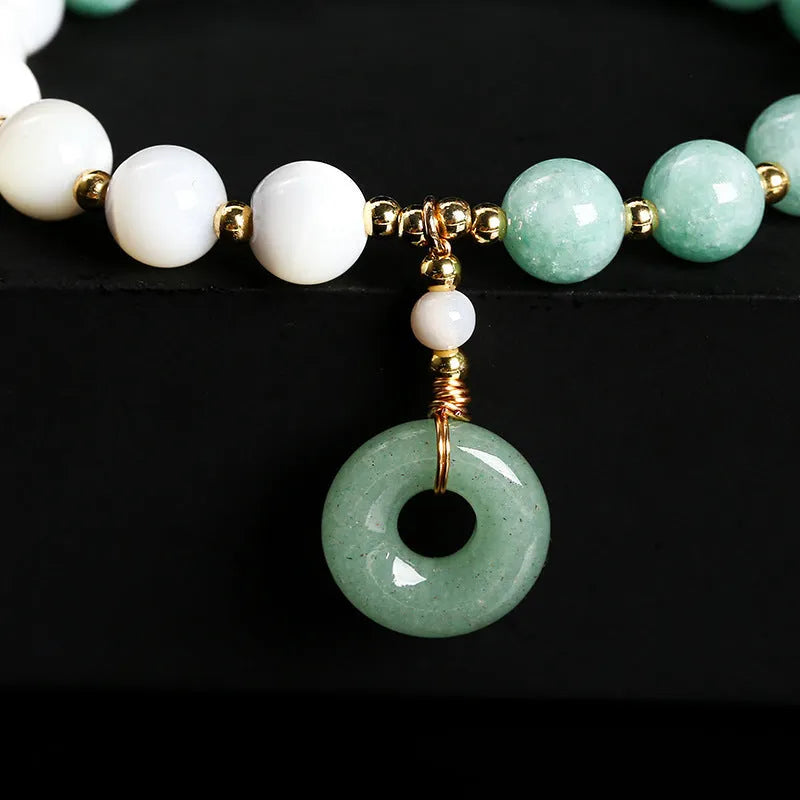 Women's Burma jade bracelet with copper horseshoe screw safety clasp showing 8mm round beads